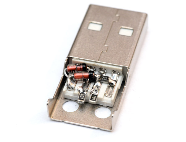 Diodes and surface mount resistors soldered directly to the inside of a USB plug