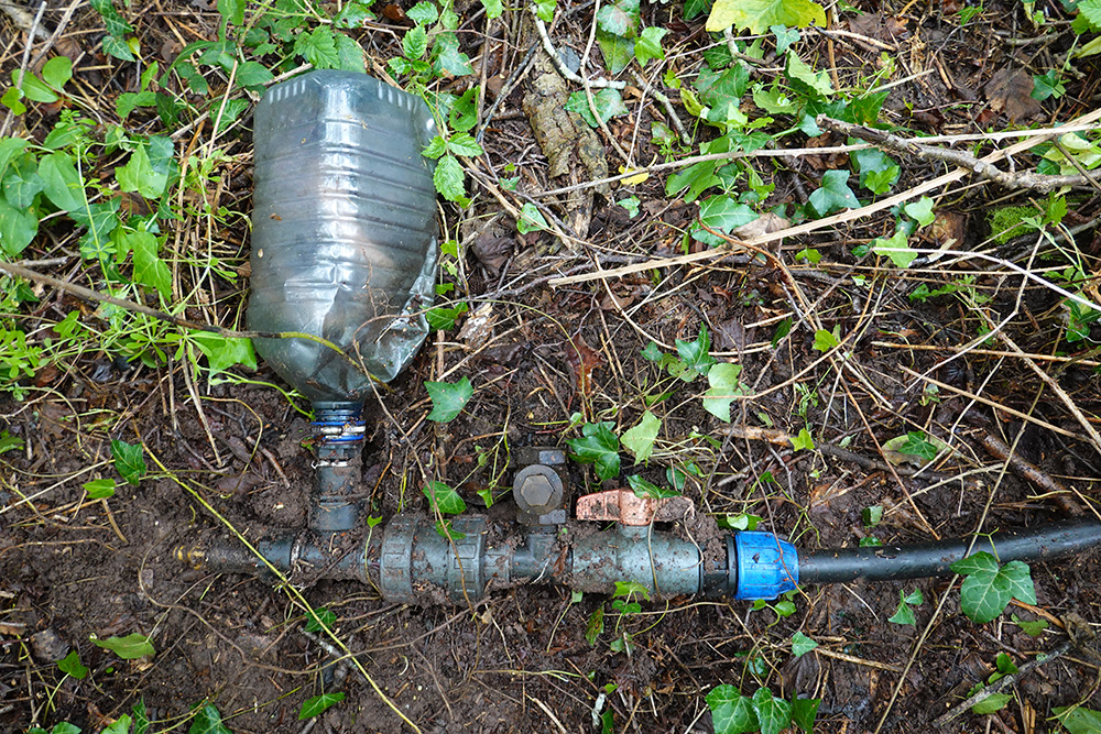The ram pump covered in soil